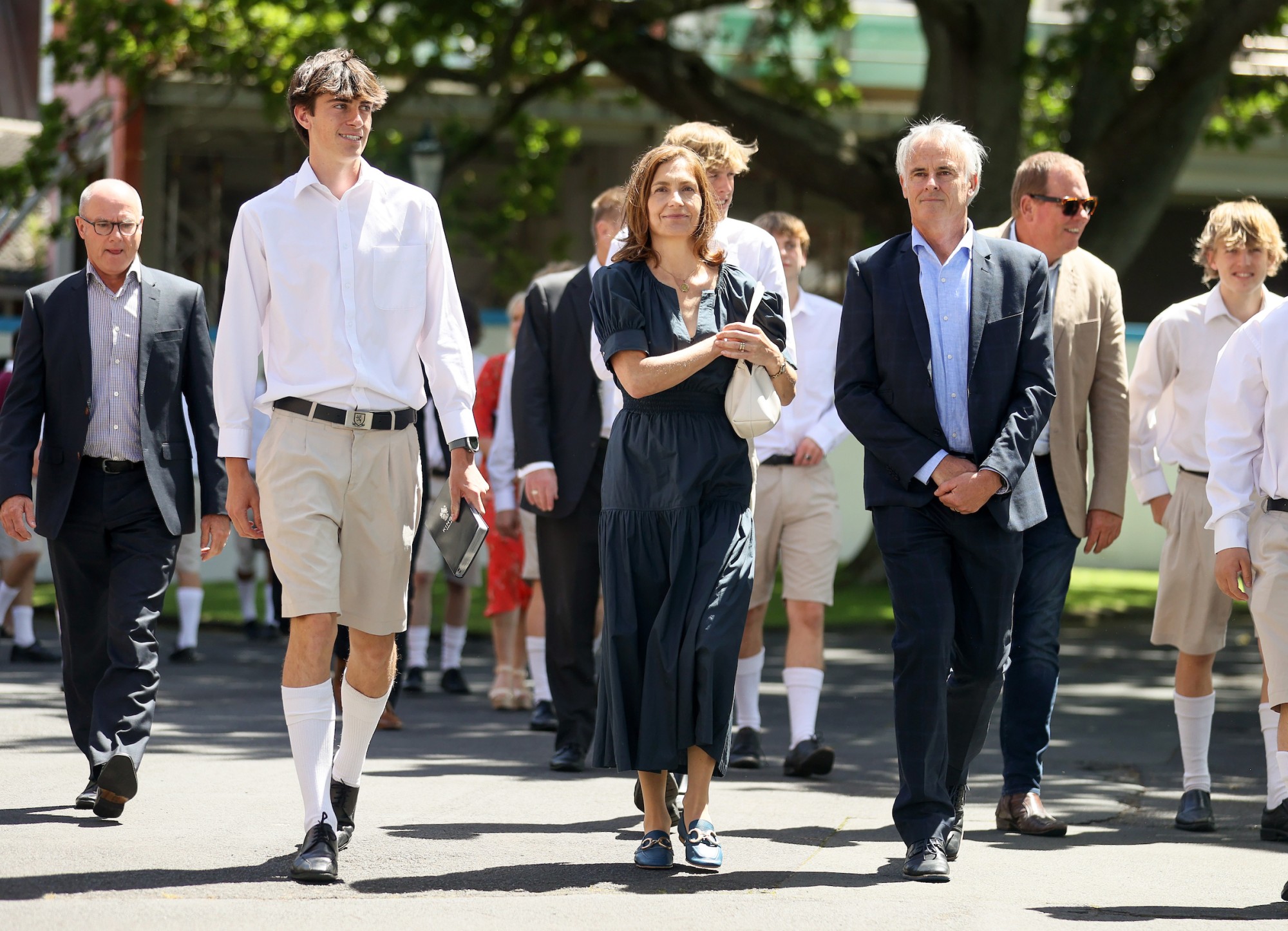 Year 13 leavers walk along drive