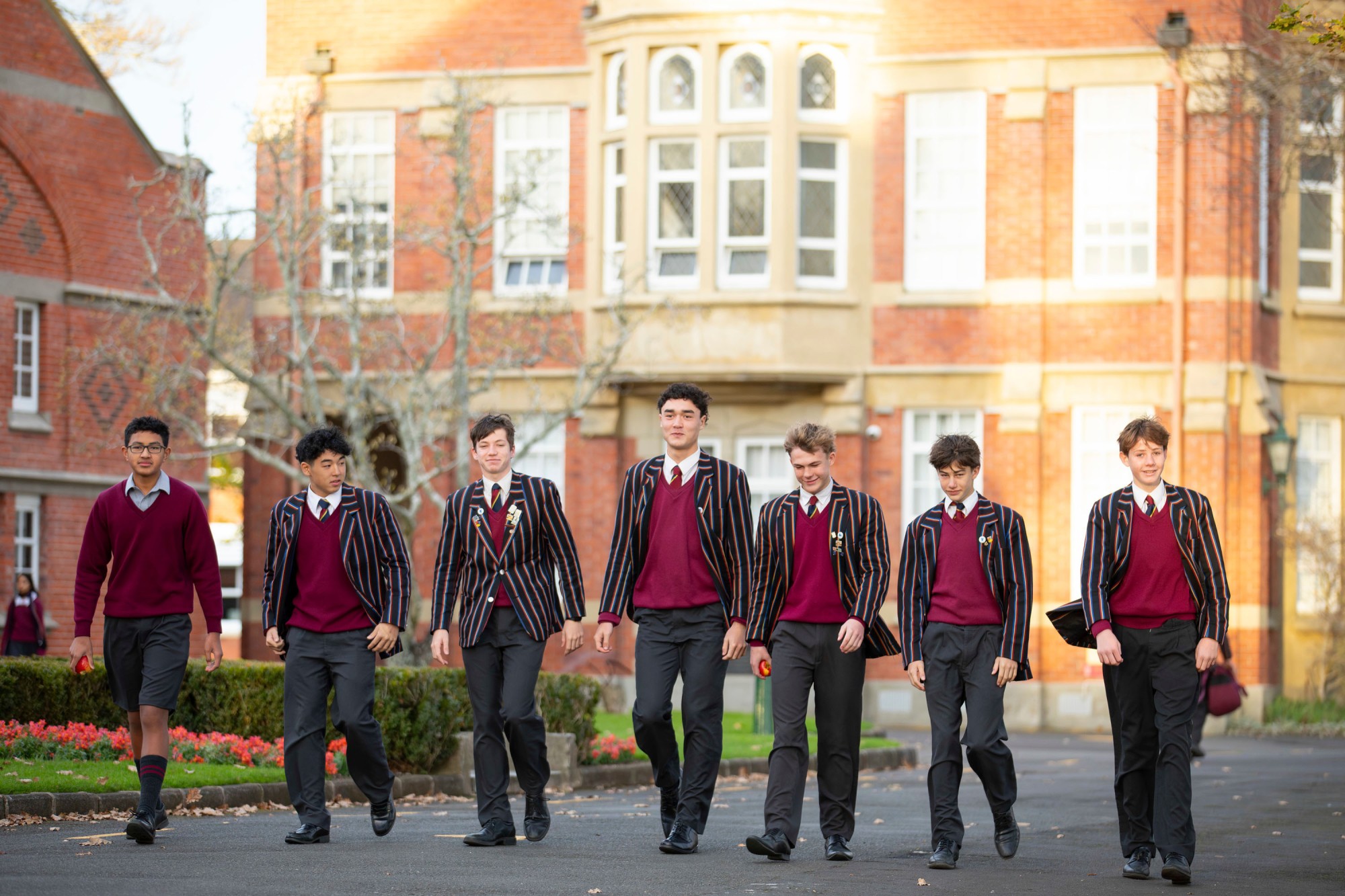 A group of boys walking along the drive