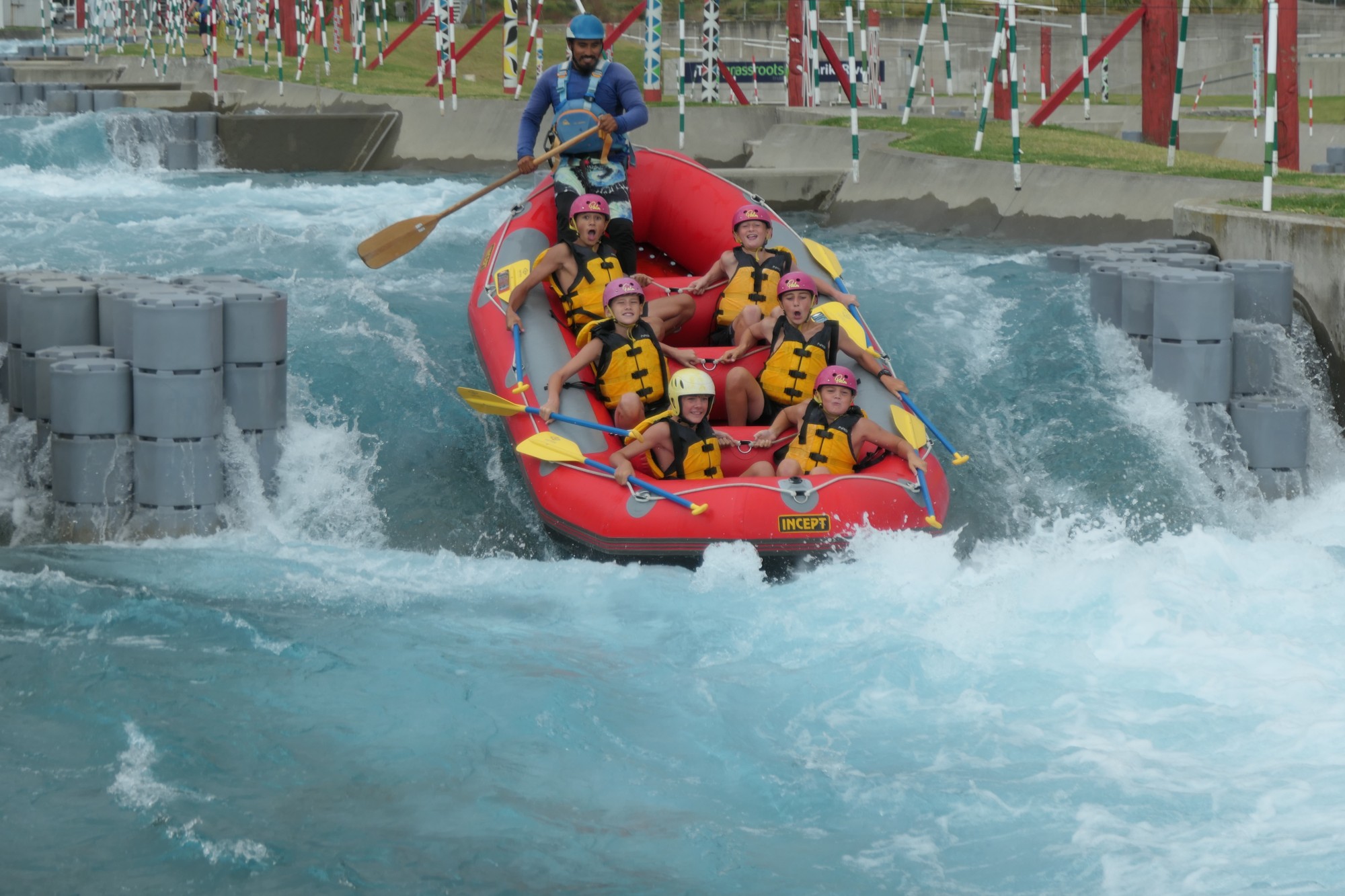 Boarding Students going down waterfall in raft